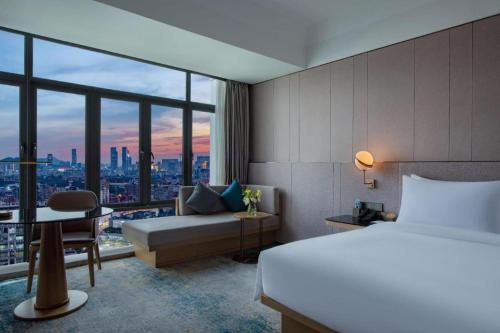 Ένα ή περισσότερα κρεβάτια σε δωμάτιο στο Onejee Hotel Shenzhen