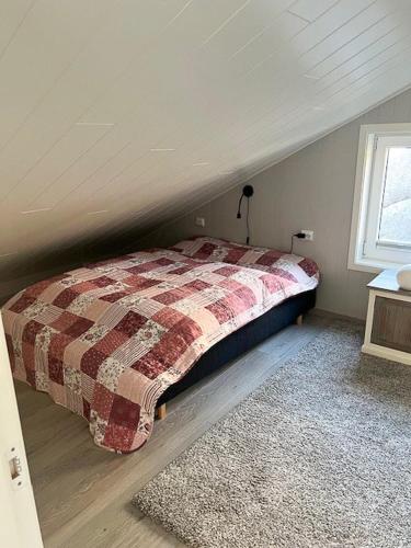 a bedroom with a bed in a attic at Scenic Cabin With Panoramic Views In Jæren in Sirevåg