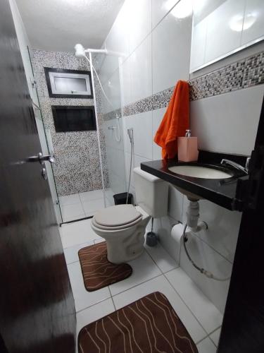 a small bathroom with a toilet and a sink at Casa dos Demeries in Triunfo