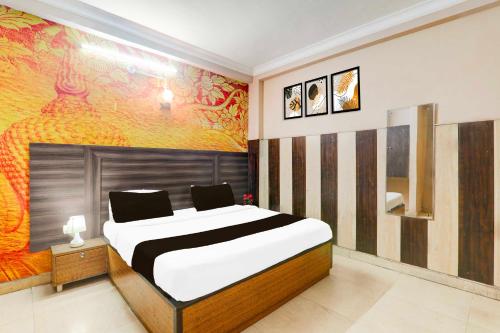 a bedroom with a bed and a painting on the wall at Collection O Sharda Nagar Lucknow in Lucknow