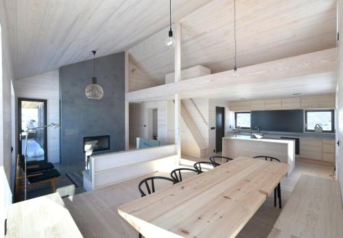 a dining room and kitchen with a wooden table at Cabin Overlooking Hallingskarvet National Park in Geilo