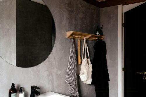 a bathroom with a mirror and a sink and a sink at Enjoy The Morning With A Dip In The Sea in Odder