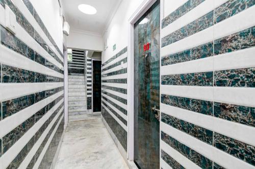 a corridor of a building with tiles on the wall at Collection O Hiland Park in Kolkata