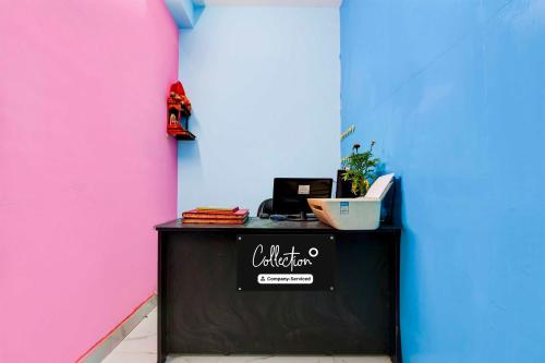 a counter in a room with a pink and blue wall at Collection O Hiland Park in Kolkata