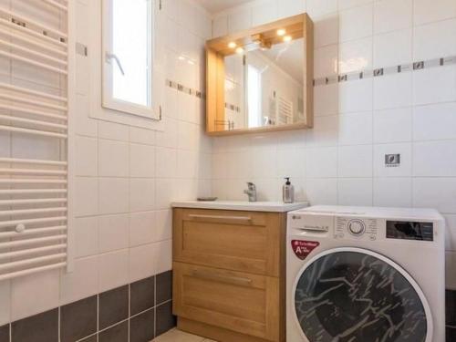 a washing machine in a bathroom with a sink at Charmante maison bois avec piscine et animaux admis - FR-1-583-475 in Vy-le-Ferroux