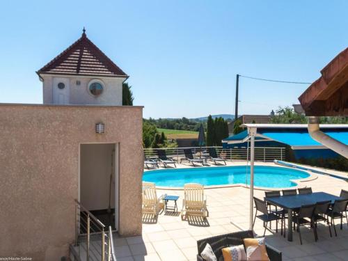 a patio with a pool and a table and chairs at Confort moderne dans les Vosges du Sud avec piscine et jacuzzi - FR-1-583-480 in Villers-lès-Luxeuil