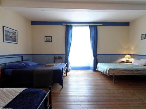 a bedroom with two beds and a window at Gîte familial 6 pers avec billard et salle de jeux - FR-1-583-488 in Anchenoncourt-et-Chazel