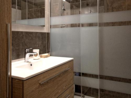 a bathroom with a sink and a shower at Charmant gîte rénové avec terrasse et parking au cœur de Montagney - FR-1-583-482 in Montagney