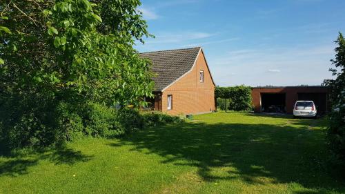 a house with a car parked in the yard at Holiday Home With Garden And Sauna In Mecklenburg in Hohen Demzin