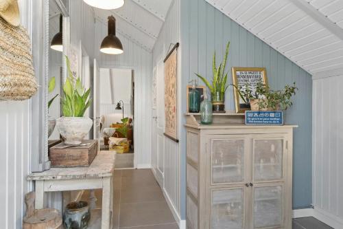a hallway with a table and a cabinet with plants at Home Near Stillinge Beach And Bildsø Forest in Slagelse