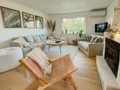 a living room with a couch and a fireplace at Stonecutter's Cottage In Scenic Lysekil in Lysekil