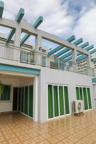 a large house with a balcony on top of it at Close by the airports and tourist attractions in Manila