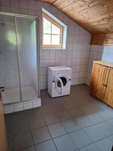 a bathroom with a washing machine and a shower at Tauernbergalm in Heiligenblut