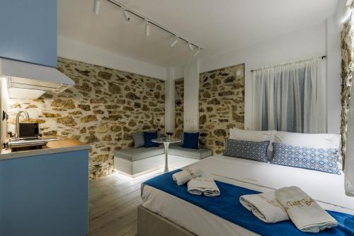 a bedroom with a large bed with towels on it at Le Petit Bati Blue in Skopelos Town