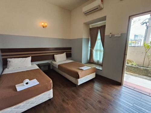 Postel nebo postele na pokoji v ubytování Cozzy Motel Malacca