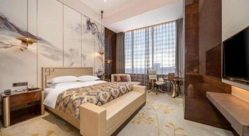 Ένα ή περισσότερα κρεβάτια σε δωμάτιο στο ZHONG DING HOTEL
