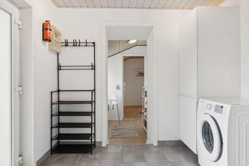 a laundry room with a washer and dryer at Cozy And Personal Village House in Hjørring