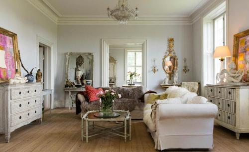 a living room with a couch and a table at Historic Atmosphere At Gelskov Estate For You in Ringe
