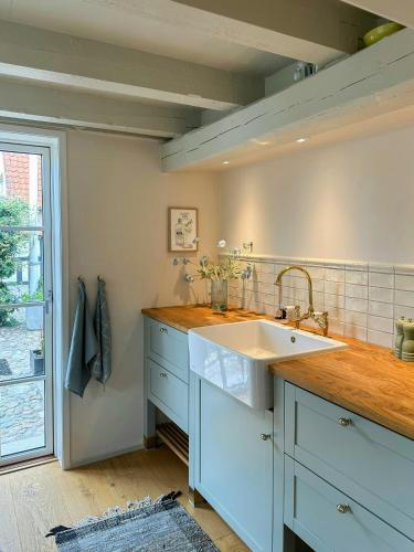 a kitchen with a sink and a counter top at Half-Timbered House With Harbor View In Ebeltoft in Ebeltoft