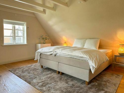 a bedroom with a large bed in a attic at Half-Timbered House With Harbor View In Ebeltoft in Ebeltoft