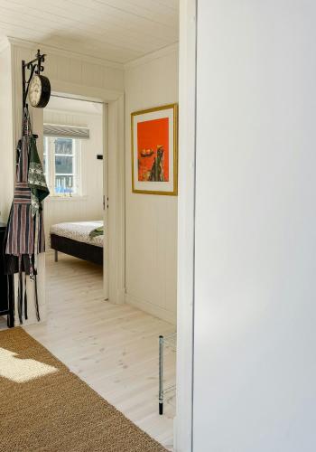 a living room with a bed and a hallway at New Timber Holiday Home With Bay Views in Kungshamn