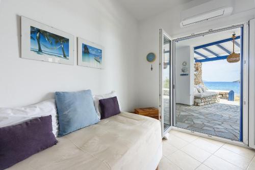 a bedroom with a bed and a view of the ocean at Villa Drios Semeli Paros in Drios