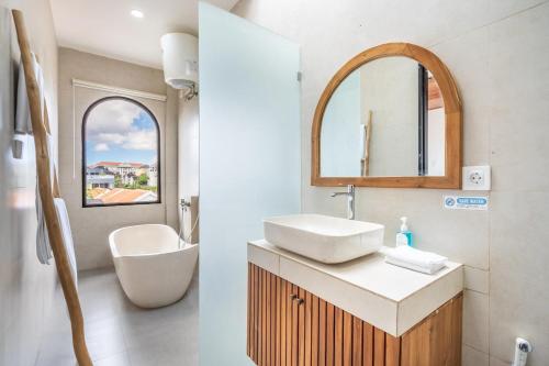 a bathroom with a sink and a mirror at Villa The ARK - A by OriVista in Dalung
