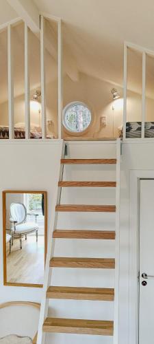 a staircase in a house with a window at Charming House Next To Forest And Sea in Kullavik