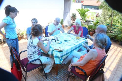 a group of people sitting around a table at Jojies Homestay Fortkochi in Cochin