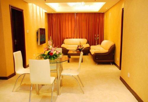 a living room with a table and chairs at Huangshan International Hotel in Huangshan