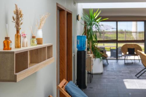 a living room with potted plants on the wall at Résidence Odalys Fleur de Sel in Guidel-Plage
