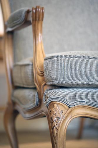 a close up of a wooden chair with a cushion at InterContinental Phoenicia Beirut by IHG in Beirut