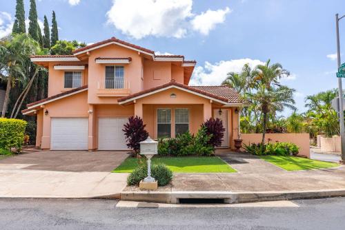 a pink house with a street sign in front of it at # Marbella Lane Posh 4BR with Spectacular Views in Kapolei