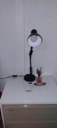 a lamp sitting on top of a white table at Double Room-C102 in Bangkok