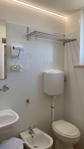 a bathroom with a toilet and a sink at Hotel Rosati in Rimini