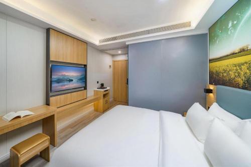Cama o camas de una habitación en Sheng Lin Na Hotel Minzhi Branch