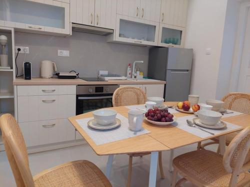 a kitchen with a table with bowls of fruit on it at Vaporia Terrace Seaview in Ermoupoli
