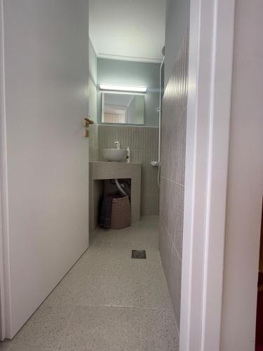 a bathroom with a sink and a mirror at Vaporia Terrace Seaview in Ermoupoli