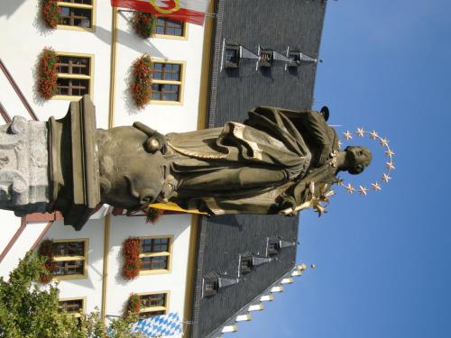 a statue of a woman on the side of a building at Hotel Schwarzes Ross in Schwarzach am Main