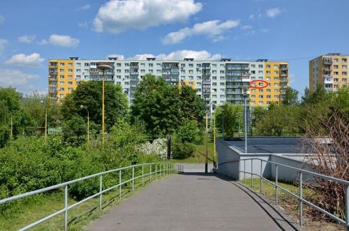 a walkway in a park with buildings in the background at Apartmán Betty in Žilina