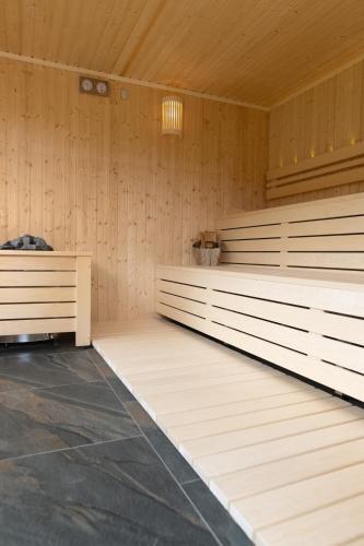 a sauna with wood paneling and a chandelier at Casa de Vacanta Magherus in Topliţa