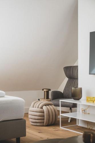 a living room with a couch and a table at Appartements Brigg & Schoner in Neuharlingersiel