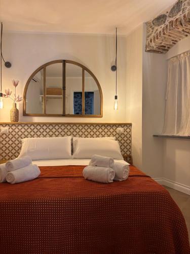 a bedroom with a large bed with two towels on it at HH Moneglia la Piazzetta in Moneglia