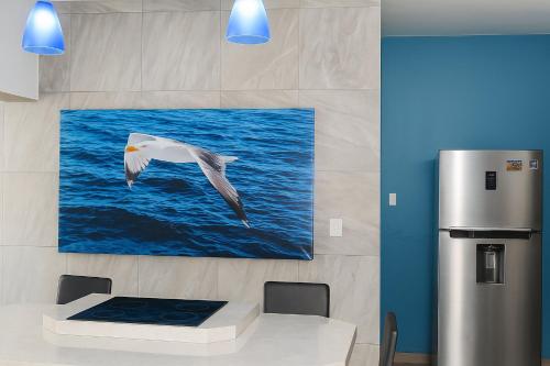 a white bird flying over the water at Regiotepec - Centro in Monterrey