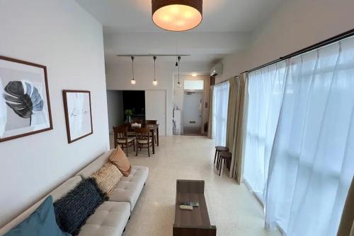 a living room with a couch and a table at パイナガマリゾート AZAMi-8 in Miyako-jima