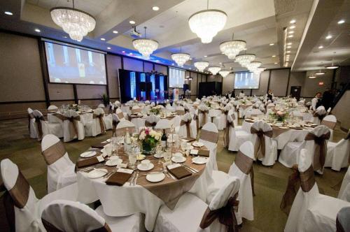 a large banquet hall with white tables and chairs at Radisson Hotel Winnipeg Downtown in Winnipeg