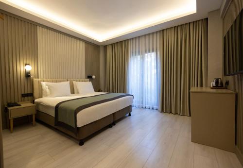 Ένα ή περισσότερα κρεβάτια σε δωμάτιο στο The Galata Glory Hotel