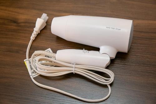 a white nintendo wii controller sitting on a table at Work Friendly Room 3 min to Station Simmons Bed WiFi and Desk in Nagoya