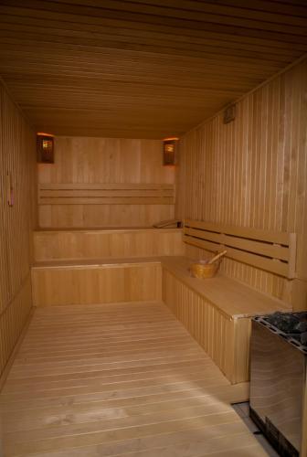 a sauna with wooden walls and a wooden floor at Azalea Hotel Baku in Baku
