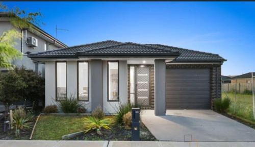 a house with a garage in front of it at St Germain Estate 4 bedrooms Clyde North home in Clyde North